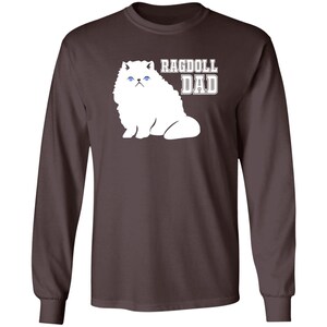 May include: A dark brown long-sleeved t-shirt with a white ragdoll cat illustration and the text "Ragdoll Dad".