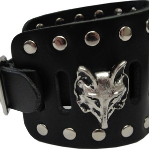 May include: Black leather bracelet with a silver fox head design and silver studs. The bracelet has a buckle closure.