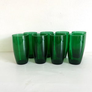 May include: Set of ten green glass tumblers. The glasses are clear and have a slightly frosted appearance.