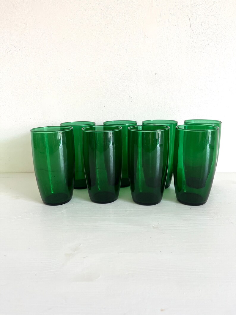 May include: Set of ten green glass tumblers. The glasses are clear and have a slightly frosted appearance.