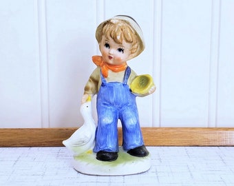 hummel boy on fence with goose