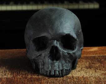 HUMAN SKULL REPLICA  (black) full size human skull replica made from plaster of Paris and painted for an off-matt finish