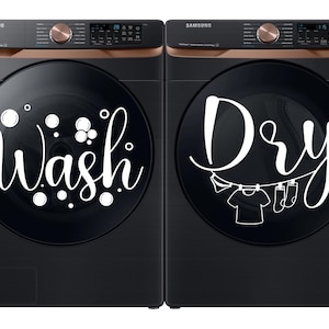 May include: Two black Samsung washing machines and dryers. The washer has the word "Wash" in white script with bubble graphics. The dryer has the word "Dry" in white script with a clothesline graphic.