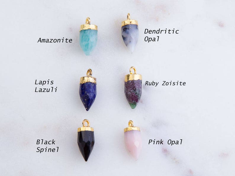 May include: Eight gold-plated gemstone pendants with different colored stones, including amazonite, dendritic opal, lapis lazuli, ruby zoisite, black spinel, and pink opal.