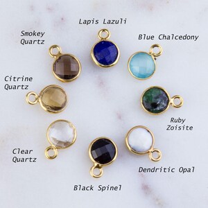 May include: Assortment of 10 gemstone beads with gold settings. The beads are: Lapis Lazuli, Smokey Quartz, Blue Chalcedony, Citrine Quartz, Clear Quartz, Ruby Zoisite, Dendritic Opal, Black Spinel.