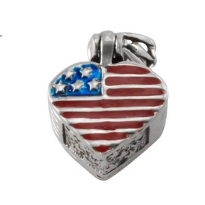 May include: A silver heart-shaped pendant with an enamel American flag design. The pendant has a loop at the top for attaching to a chain.