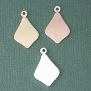 May include: Three diamond-shaped metal charms in gold, rose gold, and silver. Each charm has a small loop at the top for attaching to jewelry.