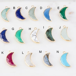 May include: Assortment of 14 gold-plated crescent moon charms with different gemstone inlays. The stones include turquoise, lapis lazuli, green aventurine, white howlite, and more.
