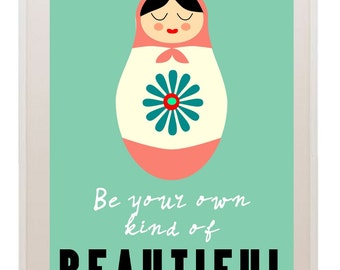 May include: A teal green background with a pink and white nesting doll illustration. The doll has a blue flower on its belly and the text "Be your own kind of BEAUTIFUL" is written below the doll.