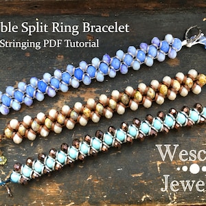 May include: Three beaded bracelets made with a double split ring technique. The bracelets are made with blue, brown, and white beads. The bracelets are on a wooden surface. The text "Wescott Jewelry" is visible in the bottom right corner of the image.
