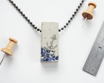 Concrete jewelry-Cast Concrete Rectangular Pendant Necklace with embedded lapis lazuli and anchor image on gunmetal finish steel ball chain