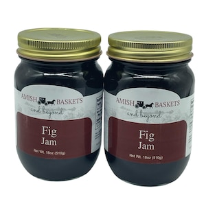 May include: Two glass jars of fig jam, each labeled "AMISH BASKETS and beyond Fig Jam Net Wt. 18oz (510g)".