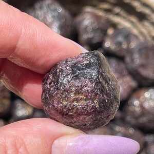 May include: A white ceramic mug with a black handle and the text "But First, Coffee" in a bold, black font. The mug is sitting on a wooden surface. The mug is 4 inches tall.