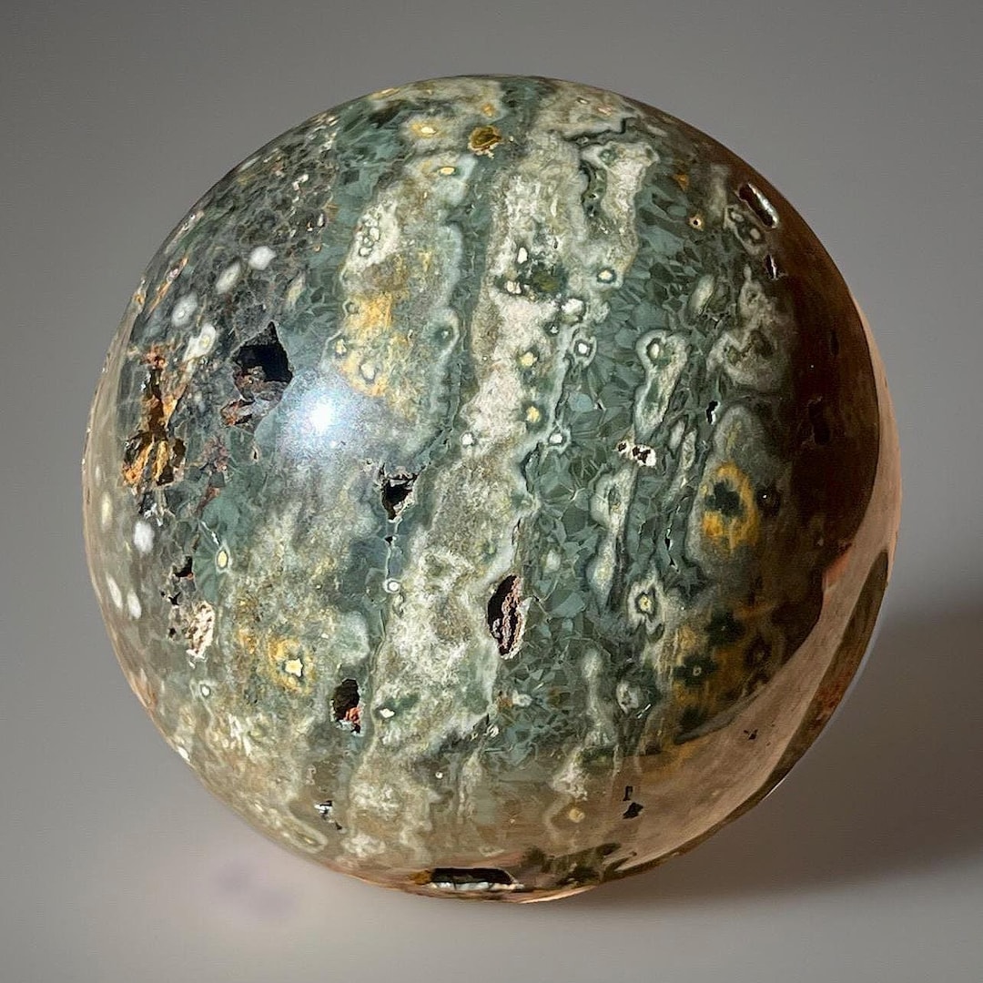 Orbicular Ocean Jasper Sphere: Green Flowers Black Quartz (62 MM