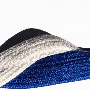 May include: Close-up of three textured ropes in white, blue, and navy. The ropes are arranged in a wavy pattern against a white background. The blue rope is in the foreground, with the white rope in the middle and the navy rope in the background.