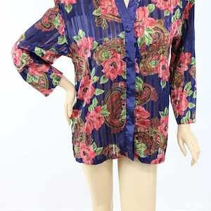 May include: A sheer, long-sleeved robe with a floral pattern. The robe features a navy blue background with vertical stripes and is adorned with red roses, green leaves, and paisley designs. It has a satin trim and button closure.