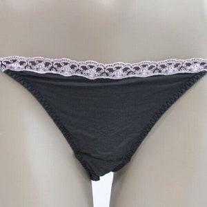 May include: Black lace-trimmed underwear with a delicate floral pattern.