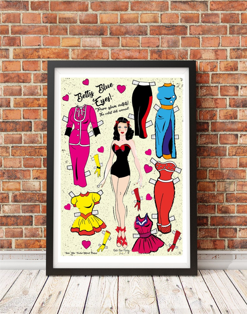 May include: A vintage-style paper doll set featuring a woman with blue eyes and red hair. The set includes a variety of outfits in pink, red, yellow, blue, and black. The text on the image reads "Betty Blue Eyes! Pure glam outfits! The cutest doll around!"