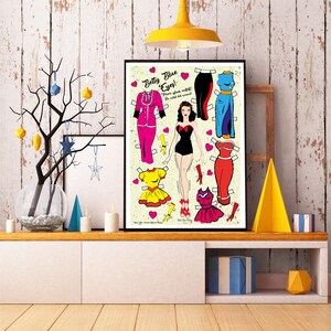 May include: A vintage-style paper doll set featuring a woman with blue eyes and black hair. The doll has a variety of outfits to choose from, including a red dress, a yellow dress, a blue dress, and a black dress. The text on the image reads "Betty Blue Eyes!" and "Dress her up, dress her down! The cutest doll around!"