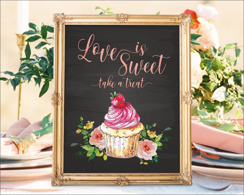 May include: A gold-framed chalkboard sign with the text "Love is Sweet, take a treat" in pink script. A watercolor illustration of a pink and white cupcake with a strawberry on top is below the text.