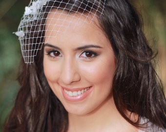 Mini birdcage veil with tiny flowers and pearls - Prices start at: