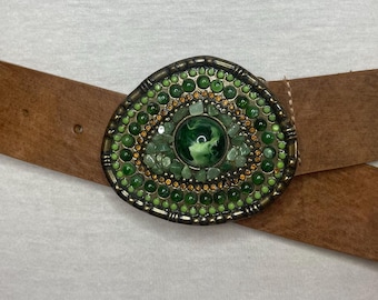 Vintage genuine cognac color leather belt wih green stones on an antique brass buckle