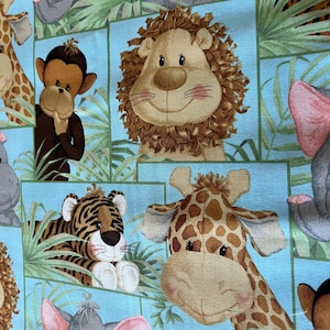 May include: A light blue fabric featuring a repeating pattern of smiling cartoon animals, including a lion, giraffe, tiger, monkey, and elephant. The animals are set against a backdrop of green foliage.