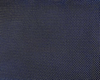 May include: Dark navy blue fabric with a repeating pattern of small white polka dots. The dots are evenly spaced across the surface, creating a classic and versatile design. This fabric is suitable for various sewing projects.