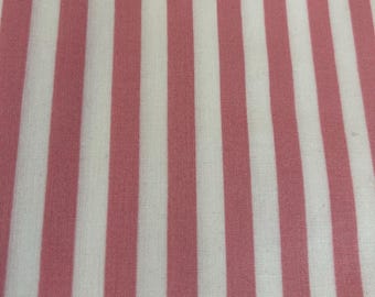 May include: Close-up of a fabric with vertical stripes. Alternating stripes of white and a soft pink color create a simple, yet visually appealing pattern. The fabric appears to be a woven material, possibly cotton or linen.