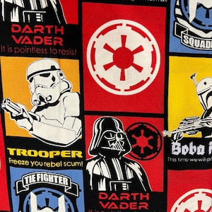 May include: A fabric featuring Star Wars characters and logos. Darth Vader, Boba Fett, and a Stormtrooper are depicted in various panels. The text includes phrases like "It is pointless to resist" and "Freeze you rebel scum!" The color scheme includes red, black, yellow, and blue.