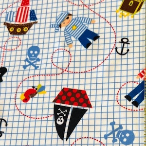 May include: A white fabric with a blue grid pattern featuring pirate-themed illustrations. The design includes a pirate, a ship, a treasure chest, a skull and crossbones, an anchor, and red parrots. The fabric is suitable for various crafting projects.