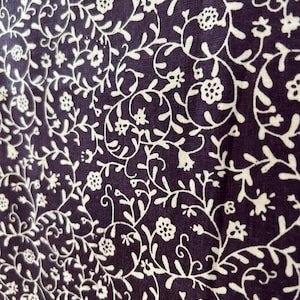 May include: A white ceramic mug with a black handle and the text "But First, Coffee" in a black, bold font. The mug is on a white surface. The mug is approximately 4 inches tall.