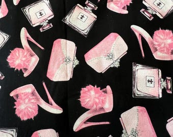 Fifth Avenue Pattern of Luxury-Items, Like High Heels, Perfume Bottles, and Handbags, in Pink, Black, and Silver Glitter.  Cotton Sold BTHY