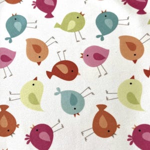 May include: A white fabric with a repeating pattern of colorful cartoon birds. The birds are in various colors, including pink, orange, blue, green, and red. Each bird has small legs and a beak.