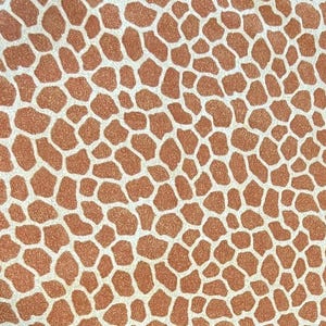 May include: Close-up of a repeating pattern resembling giraffe spots. The design features irregular, brown shapes outlined by a network of off-white lines, creating a textured, animal-inspired print.