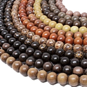 May include: A collection of wooden beads in various shades of brown, ranging from light to dark. The beads are arranged in a circular pattern, creating a visually appealing display.