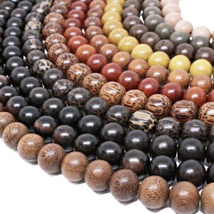 May include: A close-up of a variety of wooden beads in different colors and patterns. The beads are arranged in a circle, with the darkest beads in the center and the lighter beads on the outside.