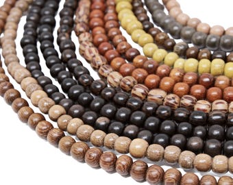 May include: A close-up of a multi-strand necklace made of wooden beads in various shades of brown, beige, and yellow. The beads are round and have a natural, rustic look.