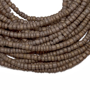 May include: A strand of brown wooden beads, perfect for jewelry making or crafting projects.