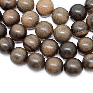 May include: A strand of dark brown wooden beads with a smooth, polished finish. The beads are round and have a natural wood grain pattern.