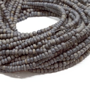 May include: A strand of gray seed beads, approximately 100 feet long, perfect for jewelry making.
