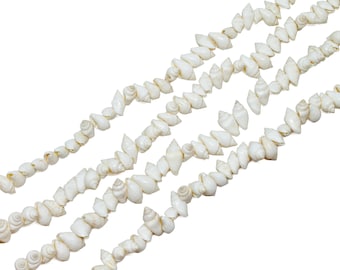 May include: A strand of white seashells strung together in a long, continuous line. The shells are all different sizes and shapes, but they are all white and have a smooth, polished finish.