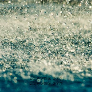 Puede incluir: Imagen abstracta de gotas de agua, con un efecto borroso. La imagen tiene una combinación de colores azul y blanco, con el texto "Copywrite 2017" repetido. El efecto general es de movimiento y textura.