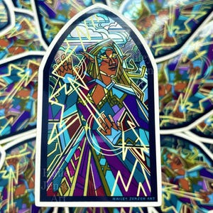 May include: A collection of stickers featuring a stained-glass style illustration of a figure with pointed ears, wearing a blue and purple outfit. The design includes gold accents and lightning bolts, with the artist's name at the bottom.