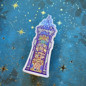 May include: A sticker of a purple and blue tower with a star on top. The tower is filled with small rooms and windows. The sticker is on a blue background with gold stars.