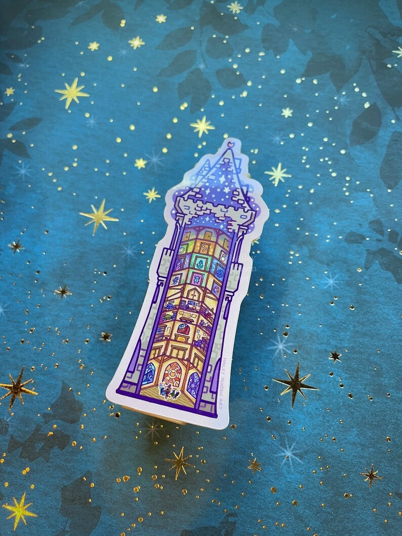 May include: A sticker of a purple and blue tower with a star on top. The tower is filled with small rooms and windows. The sticker is on a blue background with gold stars.