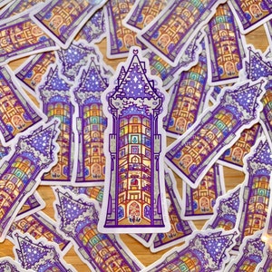 May include: A stack of purple and yellow stickers featuring a detailed illustration of a tower with a star-filled sky. The tower has many windows and a pointed roof.