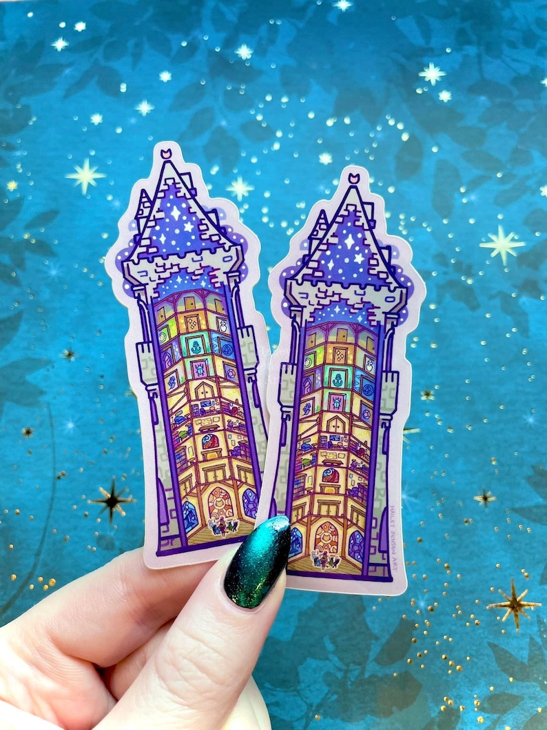 May include: Two clear stickers of a purple and blue tower with a crescent moon and stars on top. The tower has many windows and each window has a different design. The text "Millet Seed Art" is on the bottom right corner of the sticker.