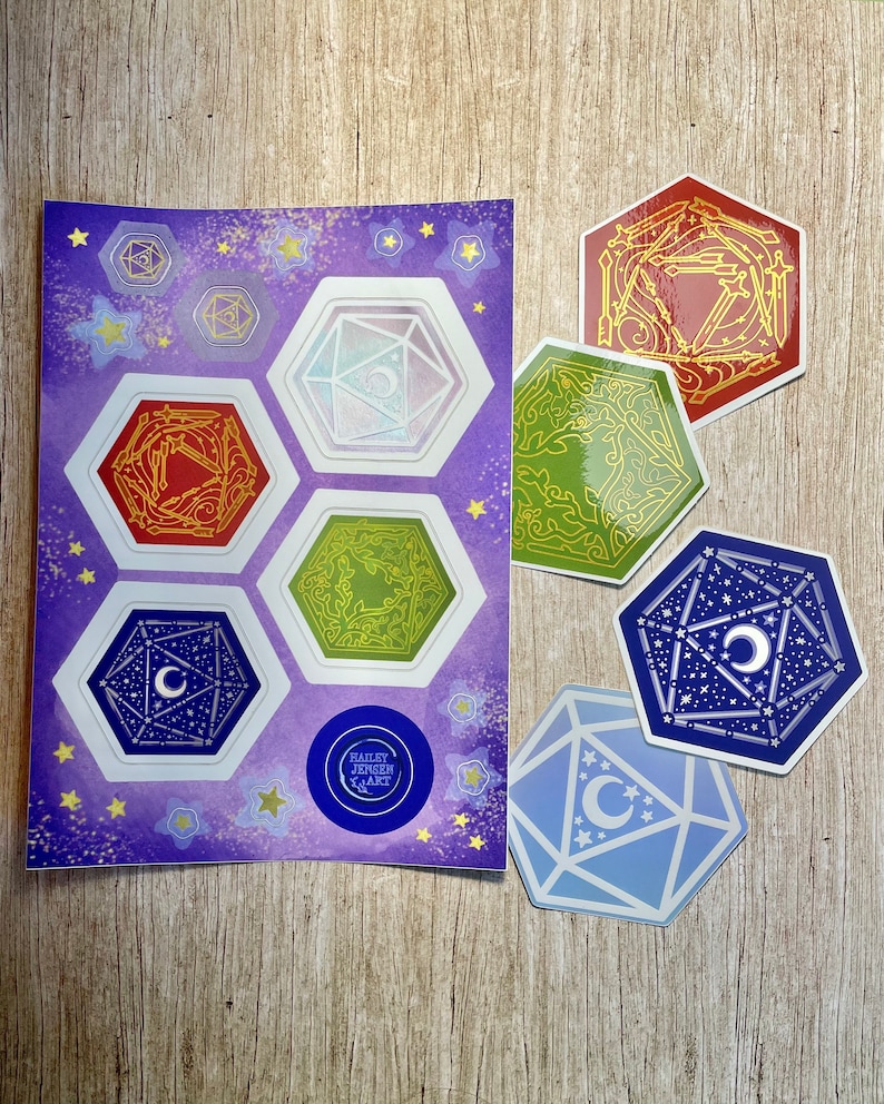 May include: A set of 7 colorful stickers featuring a variety of dice designs. The stickers are on a purple background with gold stars. The stickers are all hexagonal and have a white outline. The stickers are all different colors and have different designs. The stickers are all about 2 inches in diameter. The stickers are perfect for adding a touch of whimsy to your laptop, water bottle, or planner.