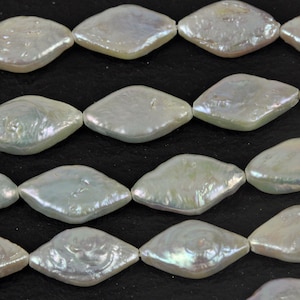 May include: Strand of iridescent, diamond-shaped pearls. The pearls have a lustrous, off-white color with subtle hints of pink and green. The beads are strung together, ready for jewelry making.